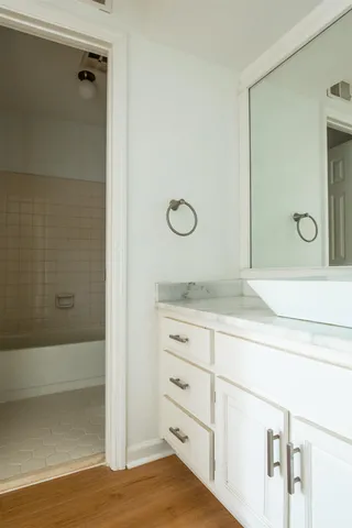 a bathroom with a shower sink and mirror