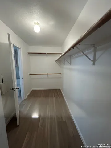 a view of a room with wooden floor and window