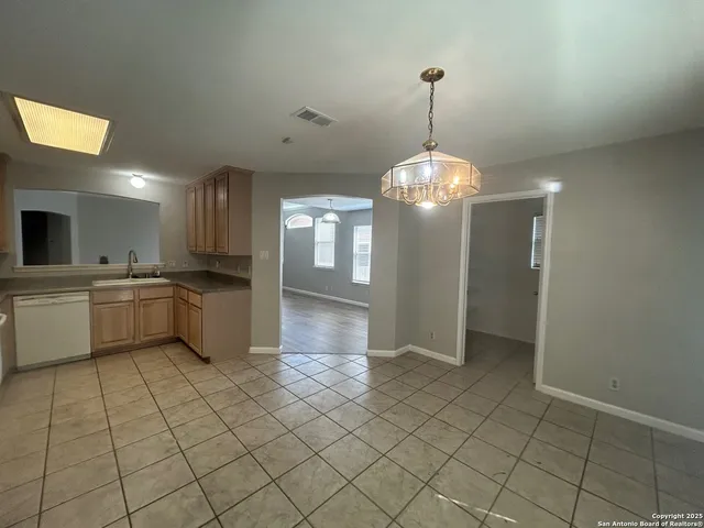 a view of a kitchen with a sink and dishwasher cabinets