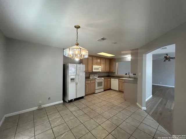 a view of a kitchen with a sink and cabinets