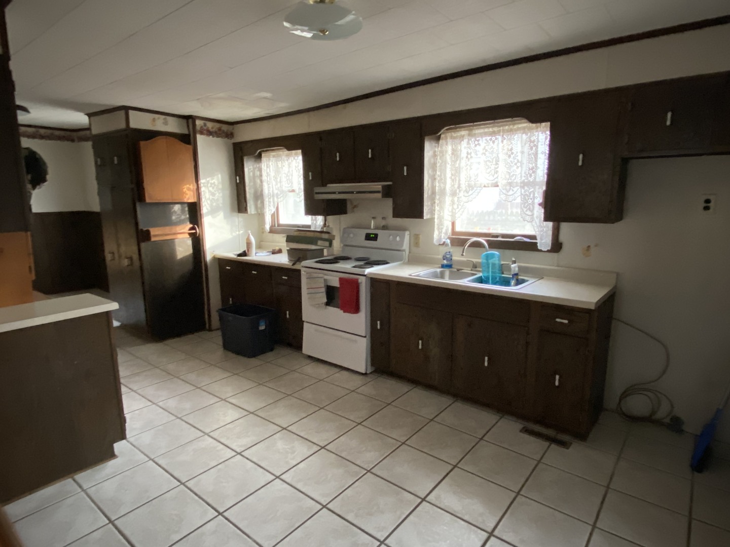111 East Elm Street Fairbury, IL 61739 - Photo 5 of 11 a kitchen with stainless steel appliances granite countertop a sink stove and refrigerator