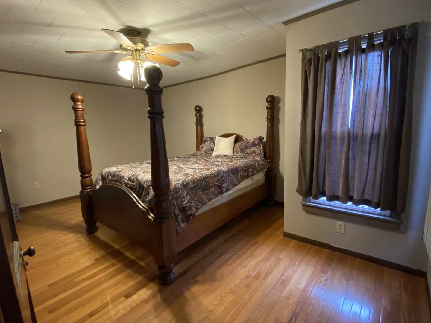 111 East Elm Street Fairbury, IL 61739 - Photo 6 of 11 a bed room with a bed and a chandelier