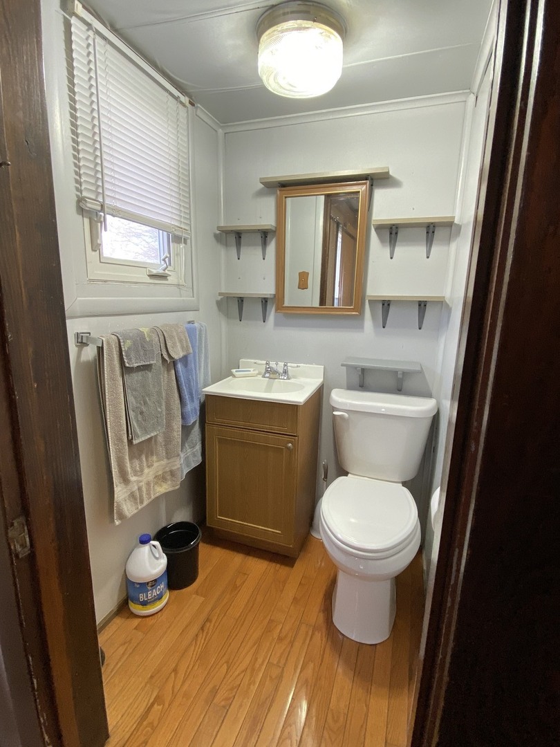 111 East Elm Street Fairbury, IL 61739 - Photo 8 of 11 a bathroom with a toilet sink and mirror