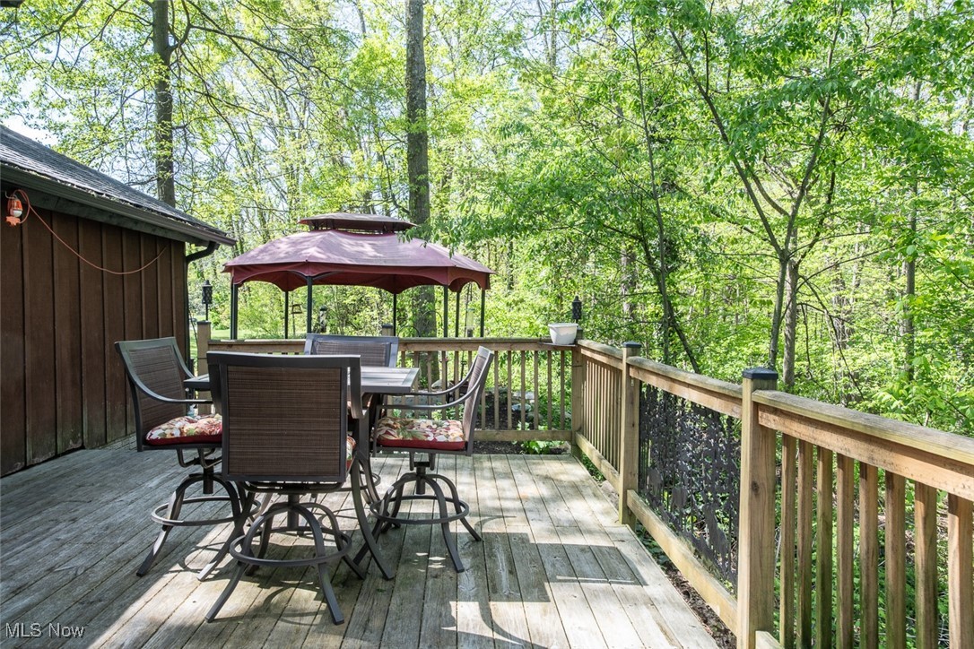 41180 Butternut Ridge Road Elyria, OH 44035 - Photo 8 of 50 Wooden terrace featuring a gazebo and outdoor dining area