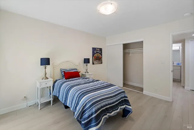 a kitchen with white cabinets and sink