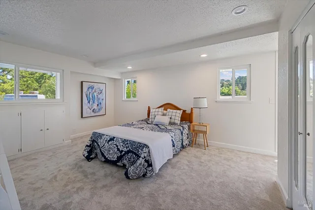 a bedroom with a large bed and a lamp