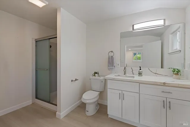 a bedroom with a bed window and table