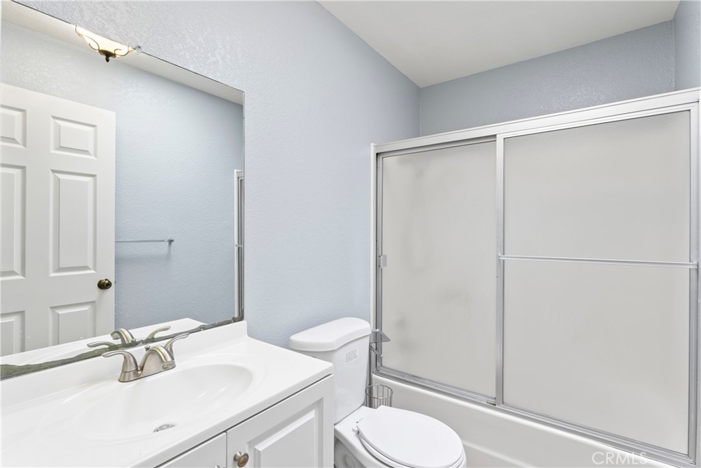 1068 Occidental Circle Redlands, CA 92374 - Photo 16 of 26 a bathroom with a sink toilet and shower