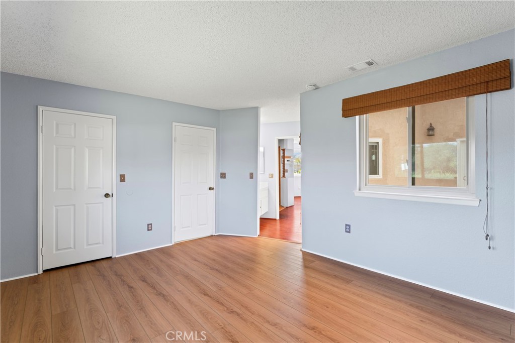 1068 Occidental Circle Redlands, CA 92374 - Photo 19 of 26 a view of a room with wooden floor and windows