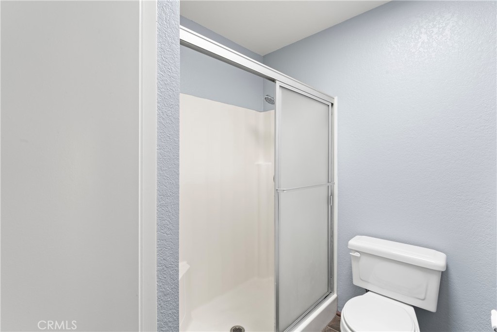 1068 Occidental Circle Redlands, CA 92374 - Photo 21 of 26 a white toilet sitting next to a shower