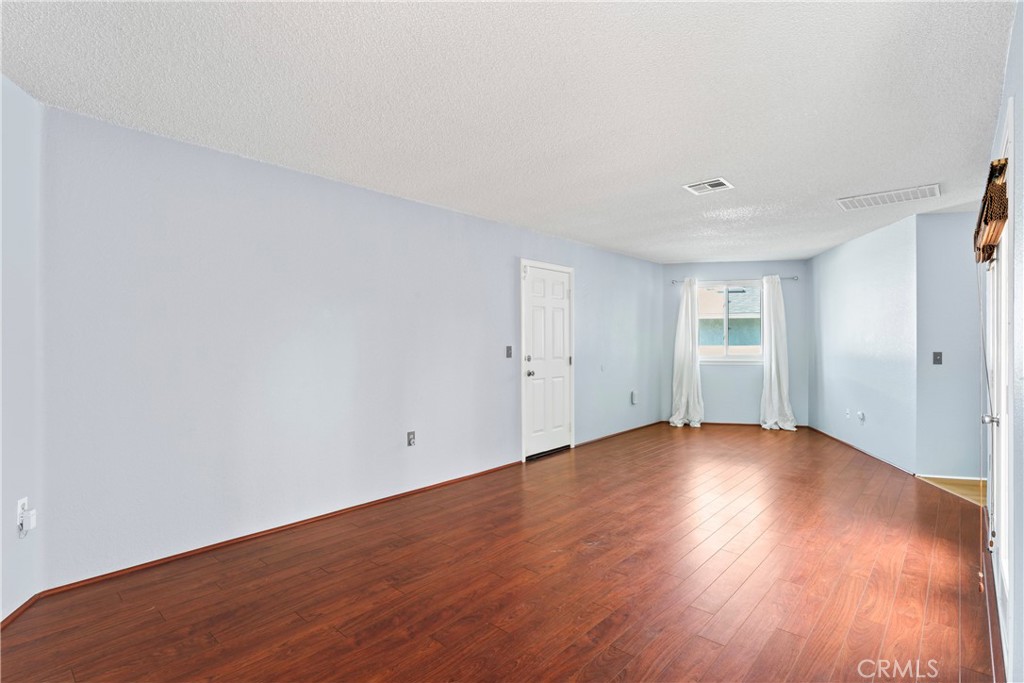 1068 Occidental Circle Redlands, CA 92374 - Photo 10 of 26 an empty room with wooden floor