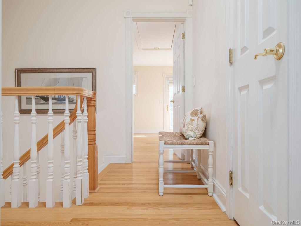 10947 North Bayview Road Southold, NY 11971 - Photo 33 of 43 Hallway with light wood-style flooring and stairway