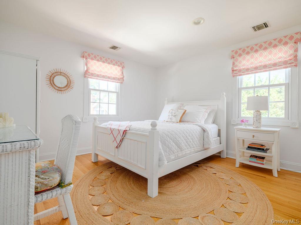 10947 North Bayview Road Southold, NY 11971 - Photo 36 of 43 Bedroom featuring light wood-style floors and multiple windows
