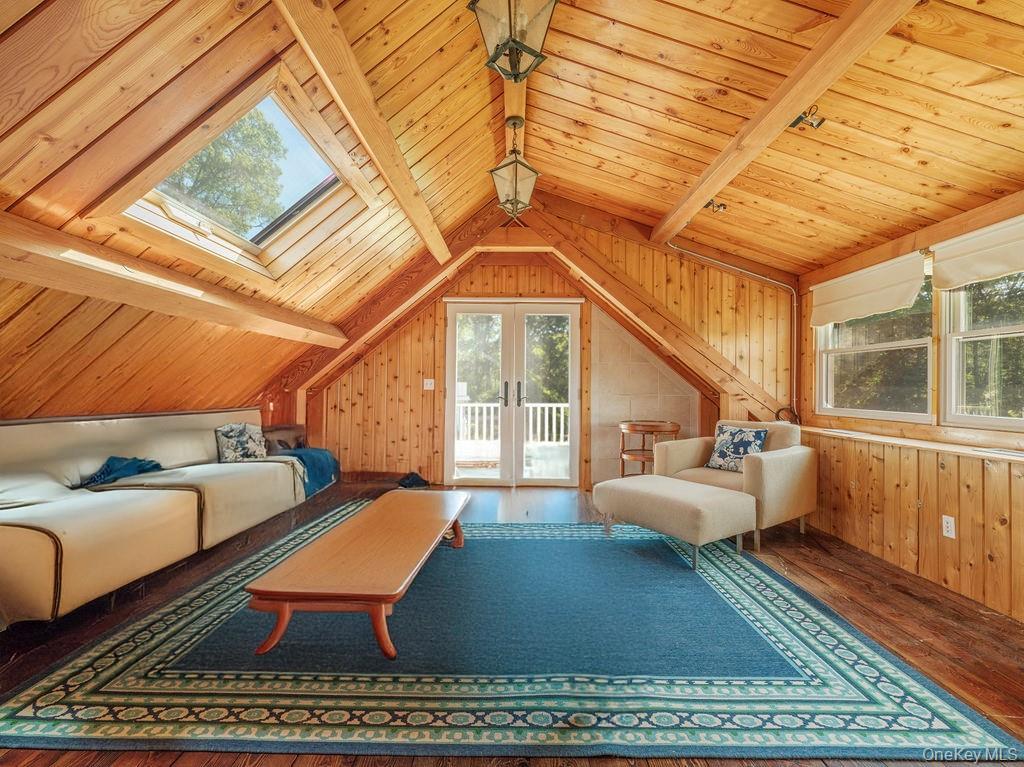10947 North Bayview Road Southold, NY 11971 - Photo 40 of 43 Bedroom featuring wood ceiling, wood finished floors, wood walls, french doors, and access to exterior