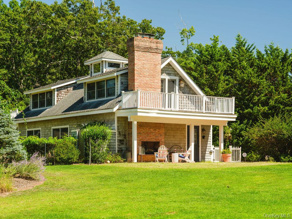 10947 North Bayview Road Southold, NY 11971 - Photo 7 of 43 Back of house with a lawn, a shingled roof, a chimney, and a patio area