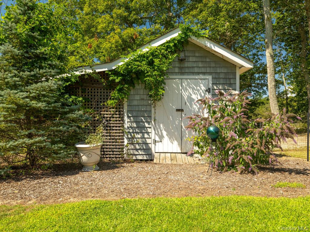 10947 North Bayview Road Southold, NY 11971 - Photo 10 of 43 View of side of home with a storage shed
