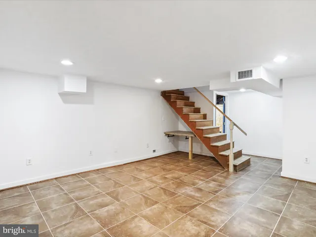 a room with gym equipment and white walls