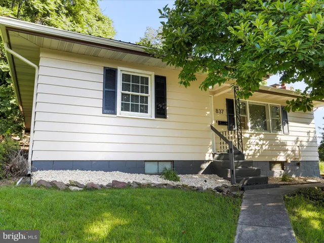 a front view of a house with a garden and yard