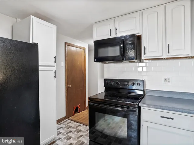 a kitchen with stainless steel appliances a stove microwave and refrigerator