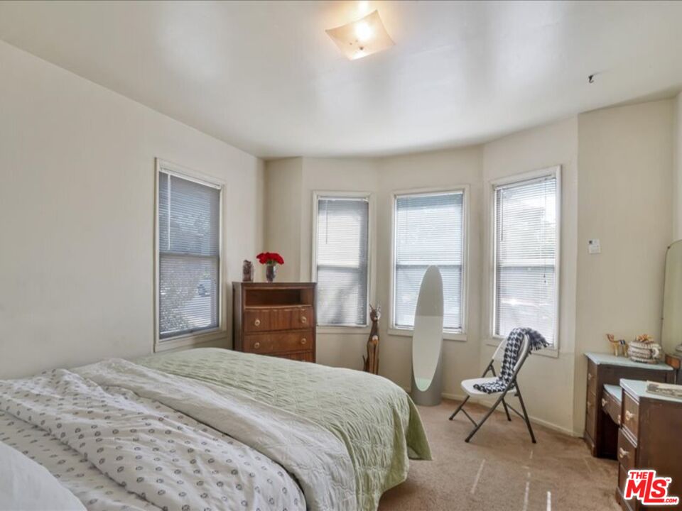 2057 Emerson Street Berkeley, CA 94703 - Photo 11 of 37 a bedroom with a bed and a chair
