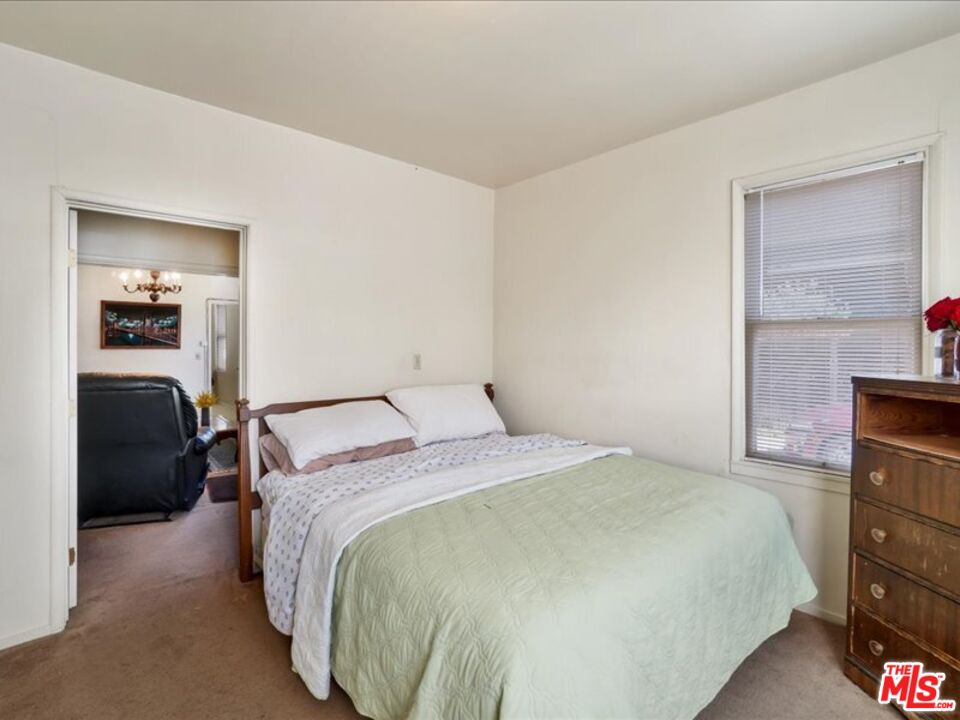 2057 Emerson Street Berkeley, CA 94703 - Photo 12 of 37 a bedroom with a bed and a large mirror
