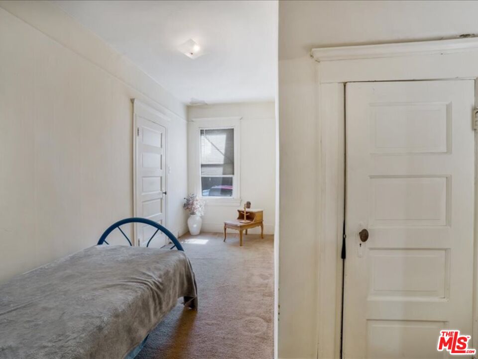 2057 Emerson Street Berkeley, CA 94703 - Photo 13 of 37 a bedroom with a bed and a window