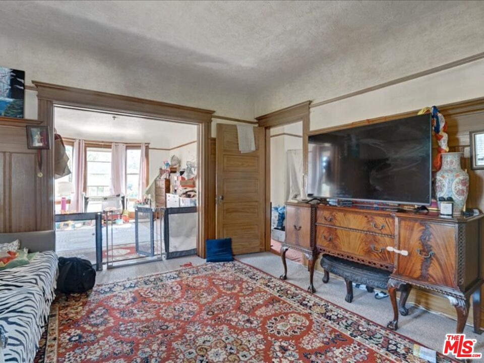 2057 Emerson Street Berkeley, CA 94703 - Photo 22 of 37 a living room with furniture and a flat screen tv