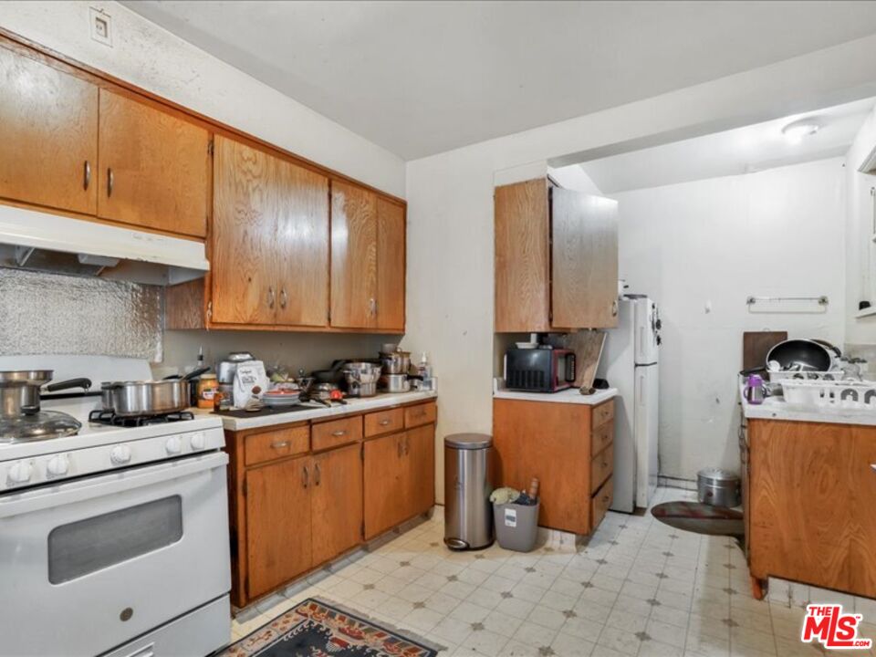 2057 Emerson Street Berkeley, CA 94703 - Photo 23 of 37 a kitchen with stainless steel appliances a stove a sink a refrigerator and cabinets