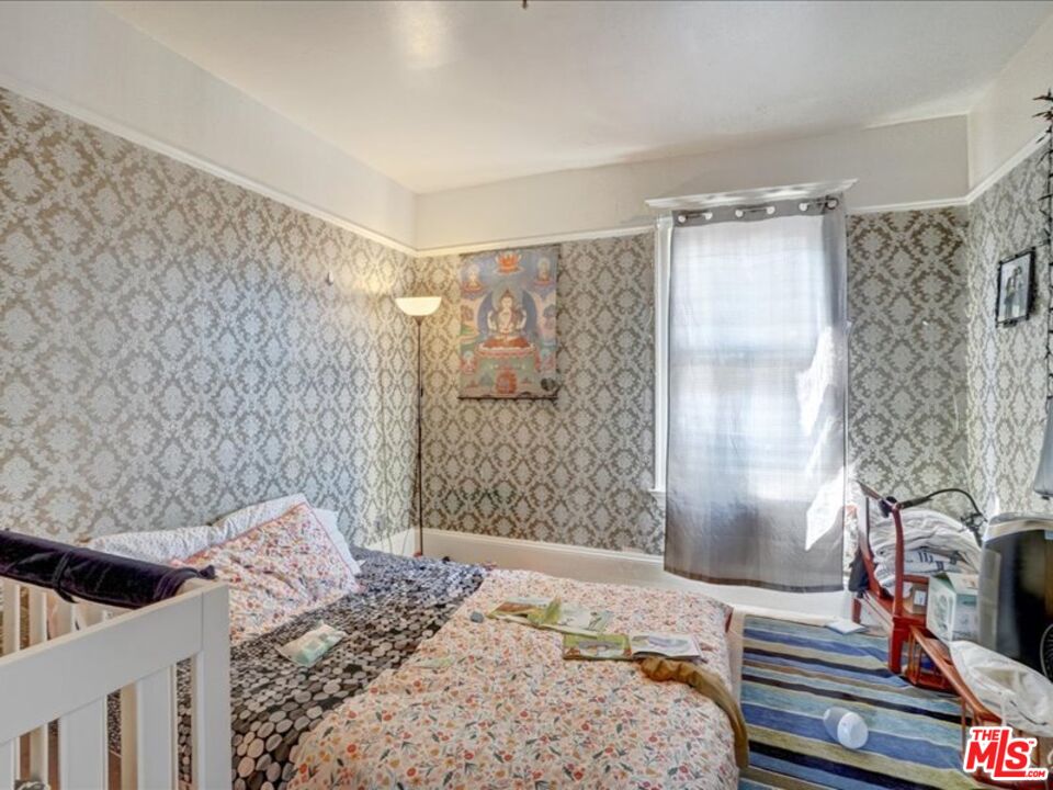 2057 Emerson Street Berkeley, CA 94703 - Photo 24 of 37 a bedroom with a bed and a dresser