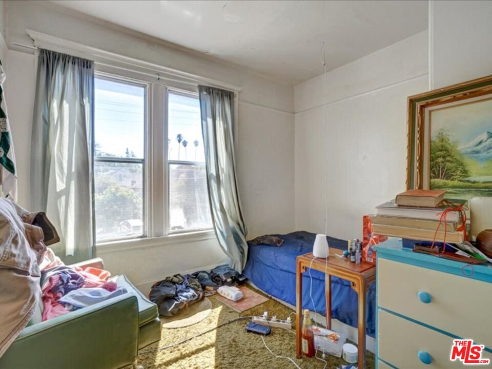 2057 Emerson Street Berkeley, CA 94703 - Photo 25 of 37 a bedroom with a bed and a window