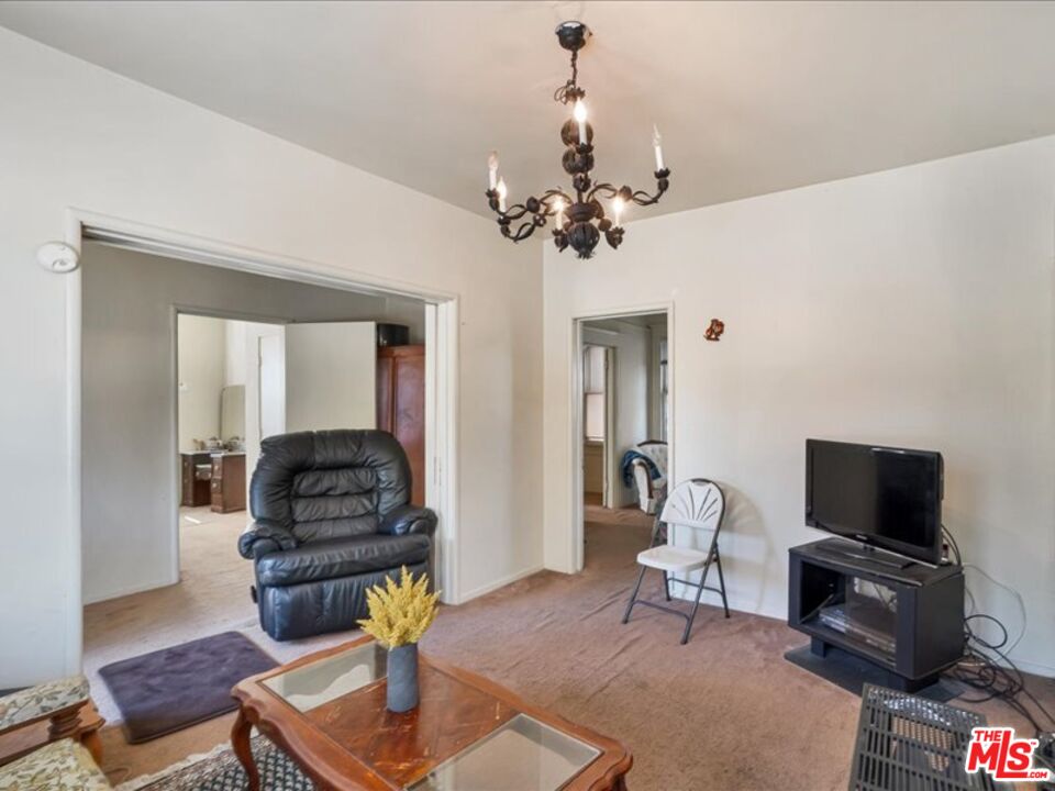 2057 Emerson Street Berkeley, CA 94703 - Photo 6 of 37 a living room with furniture a flat screen tv and kitchen view