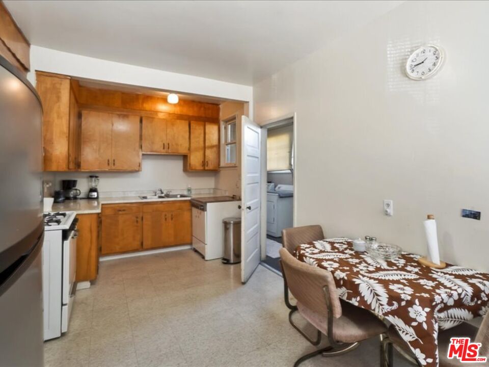 2057 Emerson Street Berkeley, CA 94703 - Photo 8 of 37 a kitchen with a sink stove and refrigerator