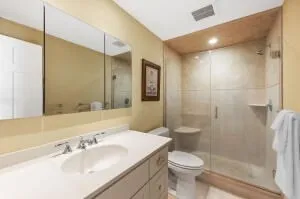 a bathroom with a sink toilet and shower
