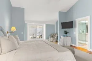 a bedroom with a bed and large windows