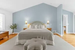 a bedroom with a bed and a potted plant