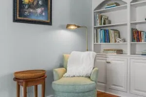 a bathroom with a toilet and a painting on the wall