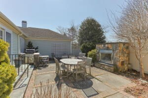 1114 Orleans Road, Unit 2 Chatham, MA 02650 - Photo 36 of 38 a view of a patio with table and chairs with wooden floor and fence