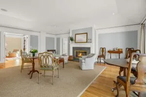 a living room with furniture a fireplace and a table