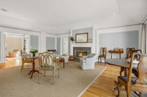1114 Orleans Road, Unit 2 Chatham, MA 02650 - Photo 4 of 38 a living room with furniture a fireplace and a table