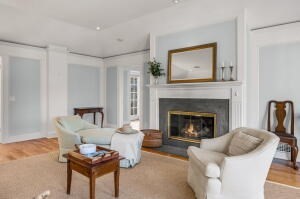 1114 Orleans Road, Unit 2 Chatham, MA 02650 - Photo 5 of 38 a living room with furniture and a fireplace