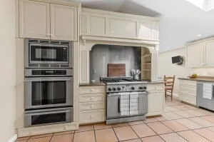 a kitchen with cabinets and stainless steel appliances
