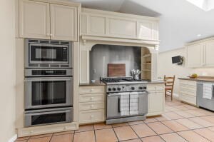 1114 Orleans Road, Unit 2 Chatham, MA 02650 - Photo 9 of 38 a kitchen with cabinets and stainless steel appliances