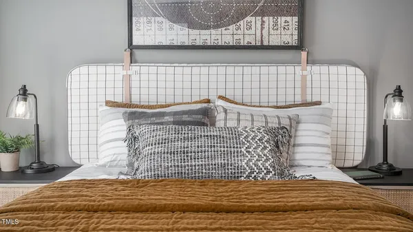 a bedroom with a bed and a painting on the wall