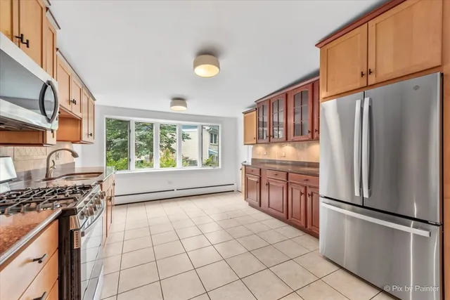 a kitchen with stainless steel appliances granite countertop a refrigerator stove top oven and sink