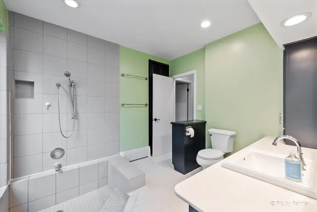 a bathroom with a sink toilet and shower