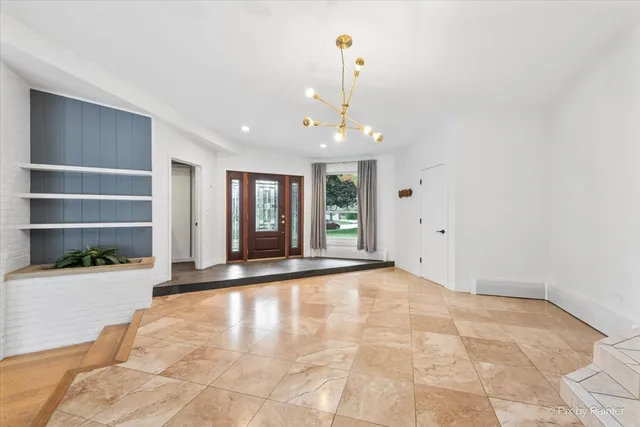 a view of an empty room with window and cabinet