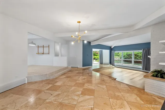 a view of a livingroom with a ceiling fan and window