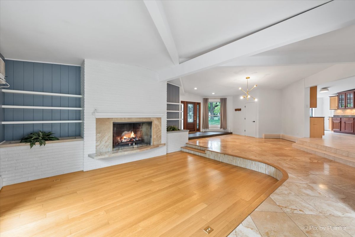 239 Beverly Road Barrington, IL 60010 - Photo 7 of 28 a swimming pool with a fireplace and large windows