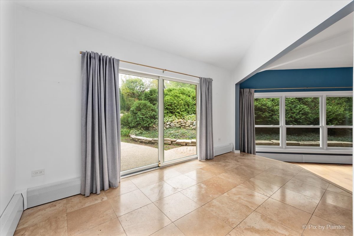 239 Beverly Road Barrington, IL 60010 - Photo 8 of 28 a view of an empty room with wooden floor and a window