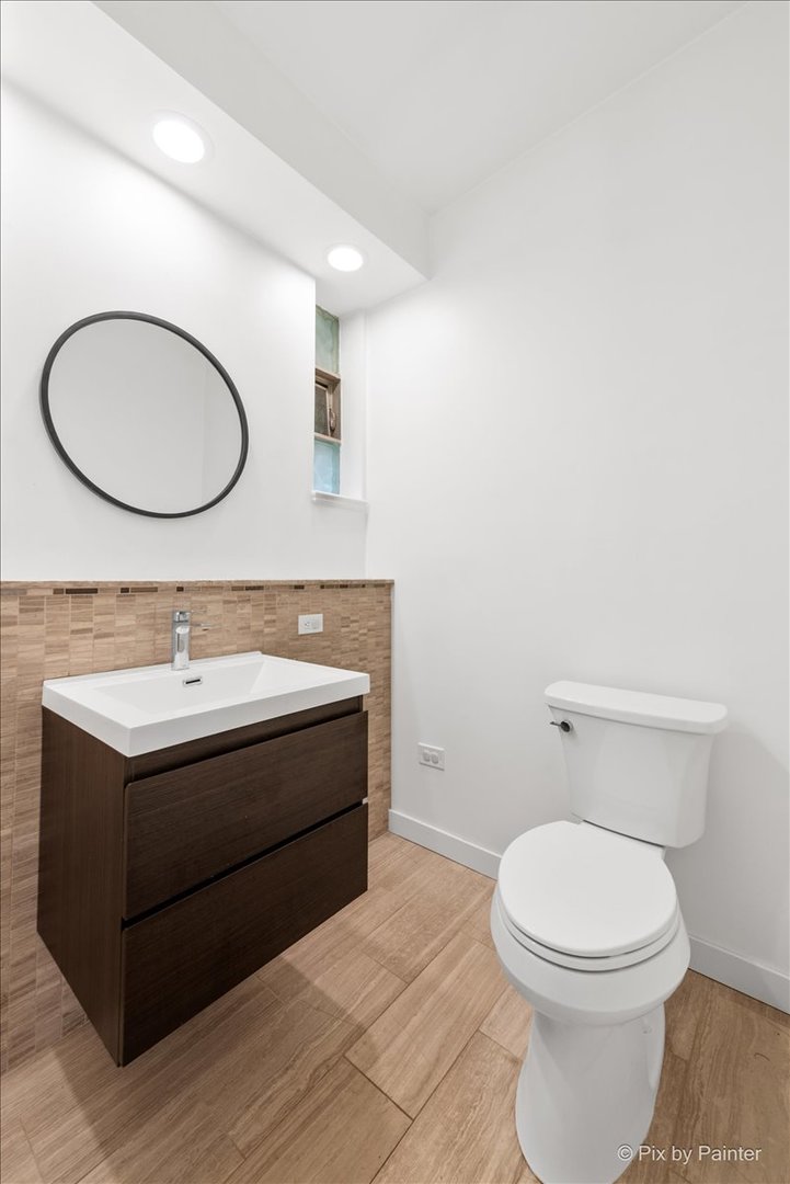 239 Beverly Road Barrington, IL 60010 - Photo 9 of 28 a bathroom with a toilet a sink and mirror